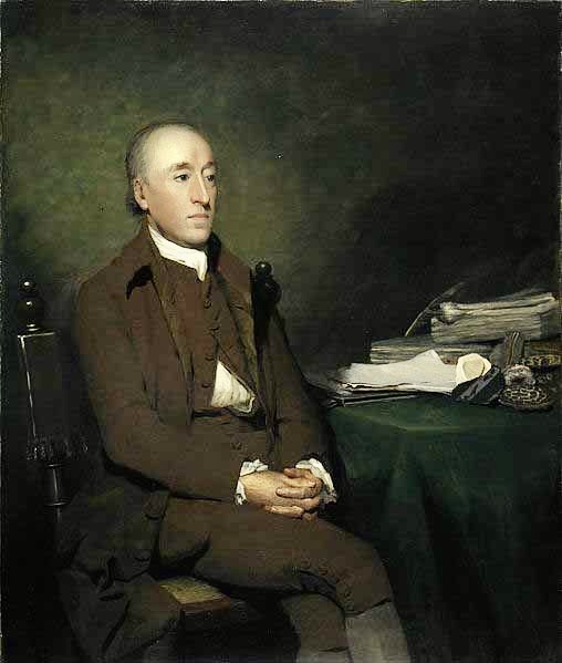 James Hutton seated at a desk piled with papers.